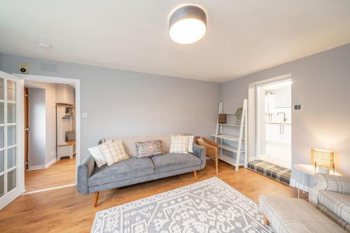 a living room with a couch and a rug at Heatherwood Cottage in New Scone