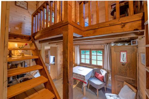 an overhead view of a wooden cabin with a spiral staircase at Chalet du Brey - Avec terrasse et jardin in Saint-Gervais-les-Bains