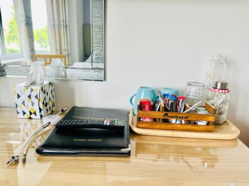 a desk with a laptop computer on a table at Oxford Guest House in Oxford