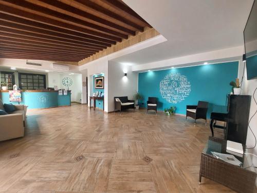 a large lobby with a waiting room with a couch and chairs at La Rosa Hotel - Selinunte in Marinella di Selinunte