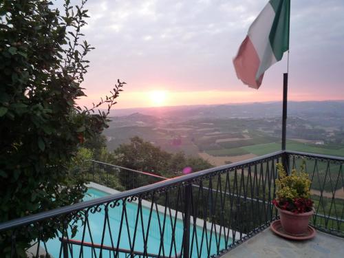a view from the balcony of a house with a flag at La Vigna Del Parroco in Verduno