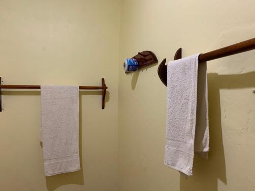 two towels hanging on a towel rack in a bathroom at Mafia Beach Bungalows sea view in Utende