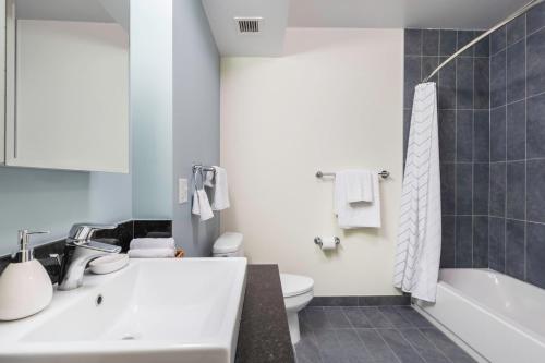 a bathroom with a sink and a toilet and a tub at Loop 1BR w Gym Pool nr Financial District CHI-211 in Chicago