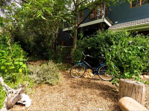 una bicicleta estacionada en un patio junto a una casa en Kriluki Accommodation en Stellenbosch