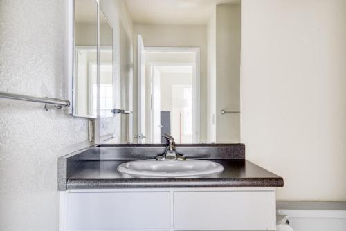 a bathroom with a sink and a mirror at Foster City 2BR w Gym 2 Pools WD nr VISA SFO-969 in Foster City