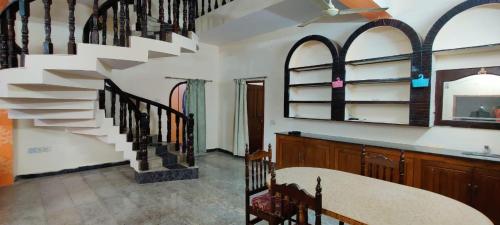 a room with a spiral staircase in a house at Feel Lyk Home in Visakhapatnam