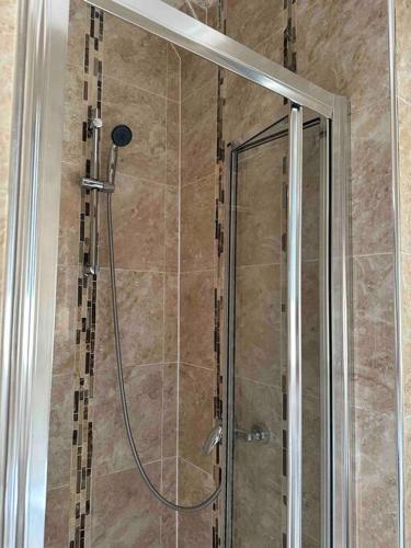 a shower with a glass door in a bathroom at Central London - Edgware Road 2 GF Bedroom Flat in London