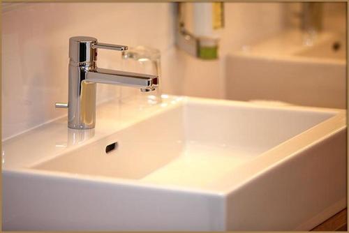 a white sink with a faucet in a bathroom at Relax- & Wanderhotel Poppengut in Hinterstoder
