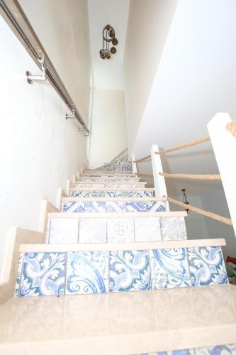 two beds in a room with blue and white tiles at Sweet Home Shekvetili 1 in Shekvetili