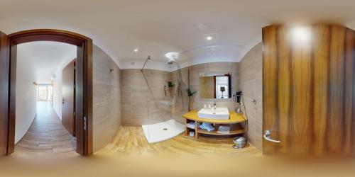 a bathroom with a sink and a mirror at Hôtel Serenada in Algajola