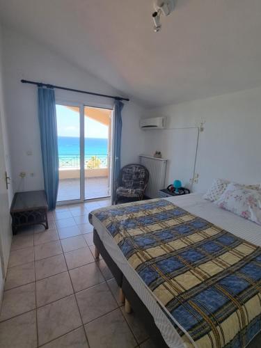 a bedroom with a bed and a view of the ocean at Aegean Villa in Mourteri