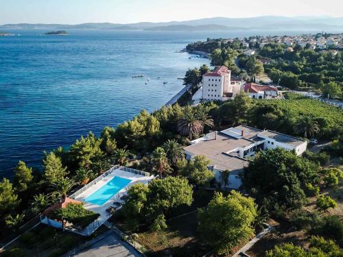 an aerial view of a house and the water at Villa Peljesac Majestic A Beautiful 8 Bedroom Villa Short Stroll Down the Path to the Beach in Orebić
