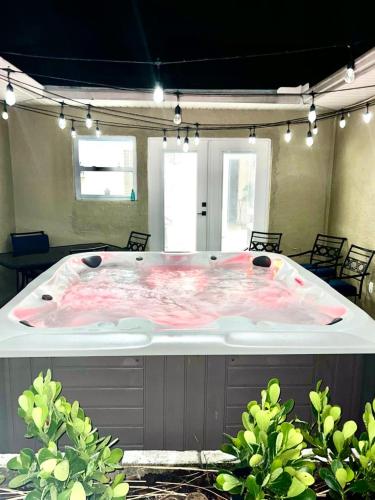 a large hot tub in a room with plants at Crest Lake Beach House in Clearwater