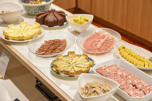 a buffet with different types of food on a table at Hakone Yumoto hotel in Hakone