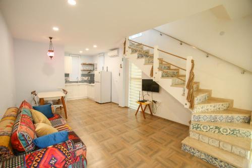 a living room with a couch and a staircase at Sweet Home 2 in Shekvetili in Shekvetili