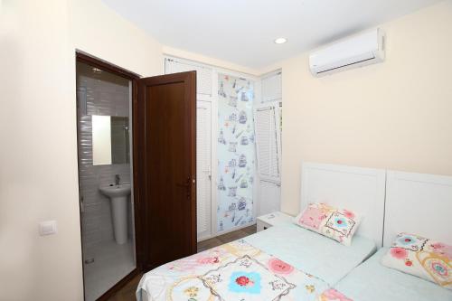 a small bedroom with a bed and a sink at Sweet Home 2 in Shekvetili in Shekvetili