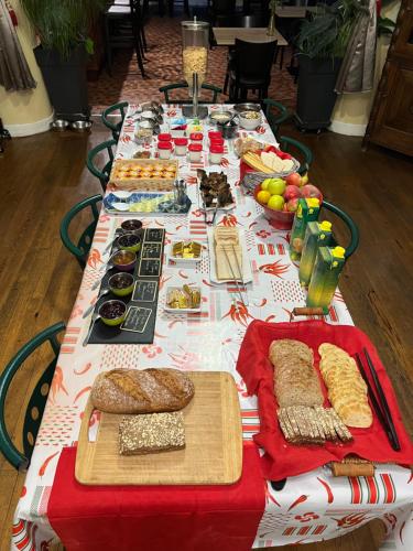 a long table with a buffet of food on it at Chambres d'hôtes L'Astazou in Gavarnie