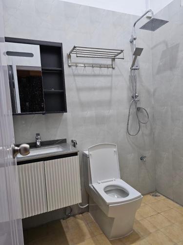 a bathroom with a toilet and a sink and a shower at Blue Haven Retreat in Thulusdhoo