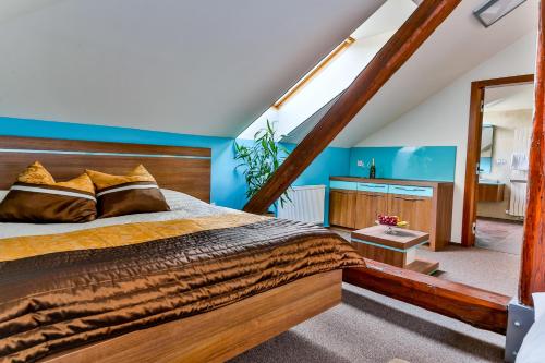a bedroom with a bed and a blue wall at Villa Aurelie in Velké Losiny