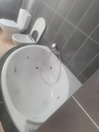 a bathroom with a white toilet and a sink at Siesta el por del sol in Santa Eularia des Riu