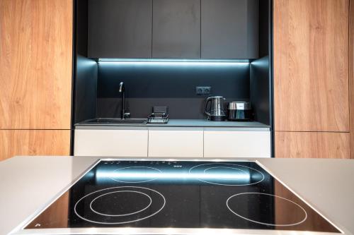 a kitchen with a black and white stove top oven at Paradise Luxury Apartments in Sofia