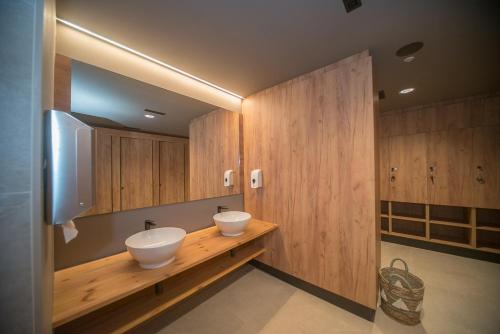 a bathroom with two sinks on a wooden counter at Oroel Hotel & SPA in Jaca