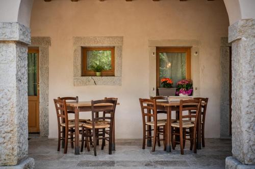 a group of chairs around a table on a patio at Agriturismo Il Bosco Camere in Vittorio Veneto