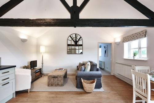 a living room with a couch and a table at Cromhall Farm in Chippenham