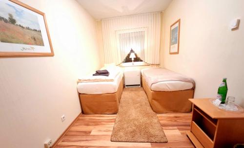 a small room with two beds and a window at Landhaus Kürrenberg in Mayen