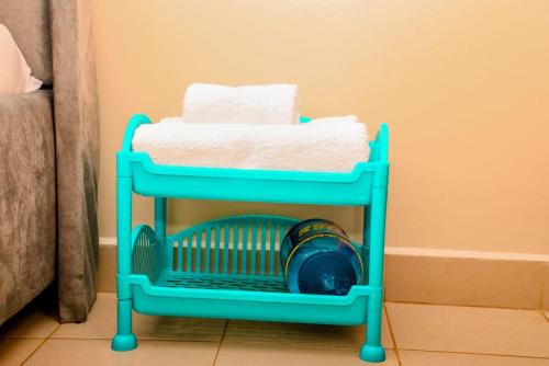 a blue cart with towels on top of a room at A&T Luxury Homestays in Kisii