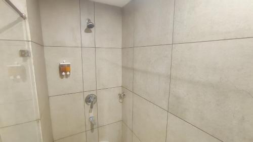a bathroom with a shower with a glass door at Mountain Retreat Kodai in Kodaikānāl