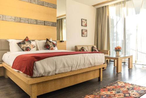 a bedroom with a large bed and a large window at Mountain Retreat Kodai in Kodaikānāl