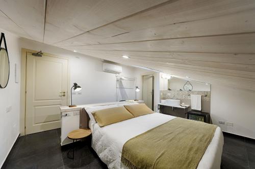 a bedroom with a large bed and a desk at Itria Palace in Ragusa