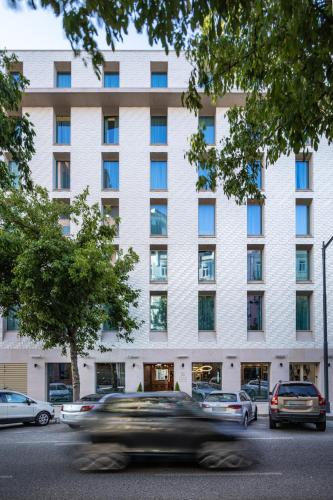 a building with cars parked in front of it at Holiday Inn Express - Lisbon - Plaza Saldanha by IHG in Lisbon