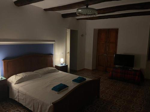 a bedroom with a large bed with two towels on it at Casa Vacanze Nonna Sissi in Maratea