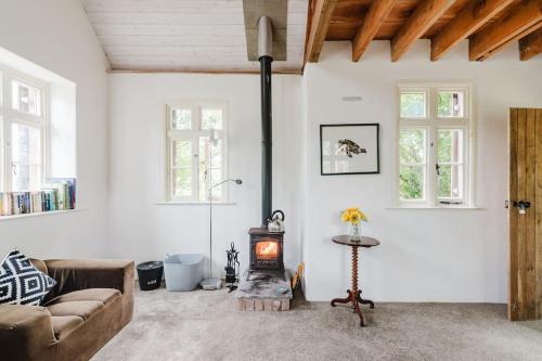 a living room with a couch and a wood stove at Wye Riverside Lodge in Llandrindod Wells