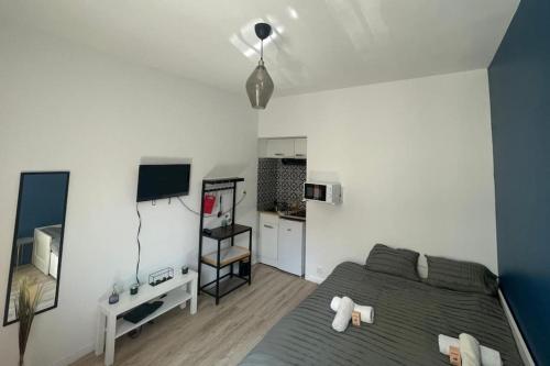 a bedroom with a bed and a television in it at Direct access to Paris & the Champs-Elysees in Asnières-sur-Seine