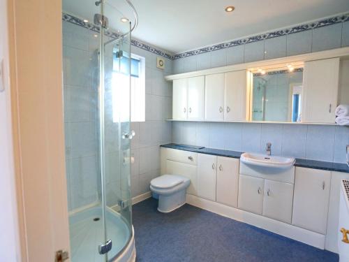 a bathroom with a toilet and a sink and a shower at Pass the Keys Family Home With Parking Next To Heaton Park in Manchester