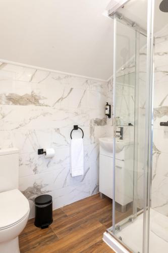 a white bathroom with a toilet and a sink at Lisboa 85 Suites & Apartments by RIDAN Hotels in Lisbon