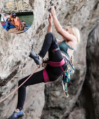 a woman rock climbing on a cliff with a group of people at Tung Quang Hotel in Cat Ba