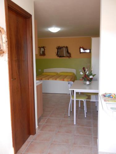 a small room with a small table and a bed at Il Sogno di Alghero - Adults Only in Alghero
