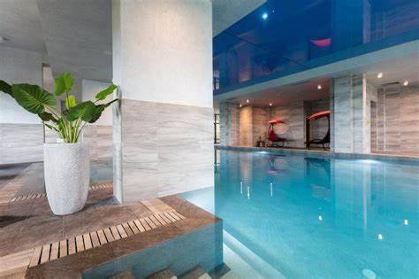 a swimming pool with a vase with a plant in it at City view in Residences in Burgas City