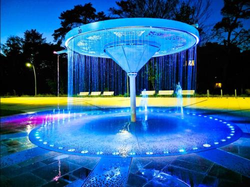 a water fountain in a park at night at visit baltic - Apartament Plażowy Casa in Świnoujście