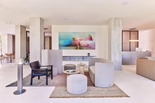 a living room with furniture and a painting on the wall at Hotel PERK in Šumperk