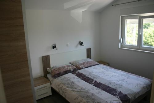 Postel nebo postele na pokoji v ubytování Apartments Ruzic