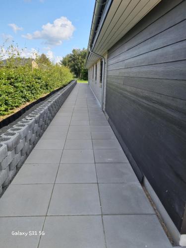 a concrete sidewalk next to a building at Bonico in Horsens