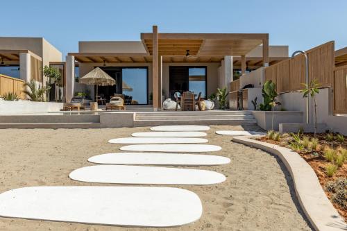 a walkway in front of a house at Unique Blue! Resort and Villas Adults Only in Karteros