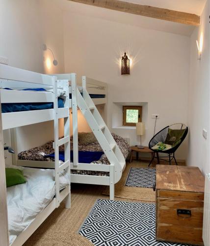 Molinot chambres d'hôtes في Alboussière: غرفة نوم مع سريرين بطابقين ومكتب