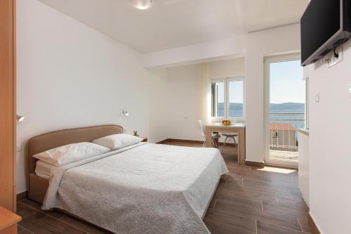 a bedroom with a bed and a view of the ocean at Villa LANA*** in Omiš