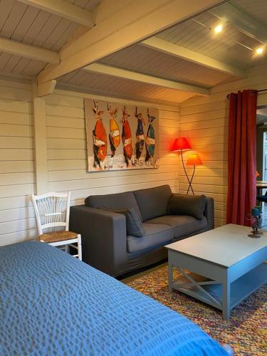 a living room with a couch and a table at Tiny House au coeur des Combes in Seillans